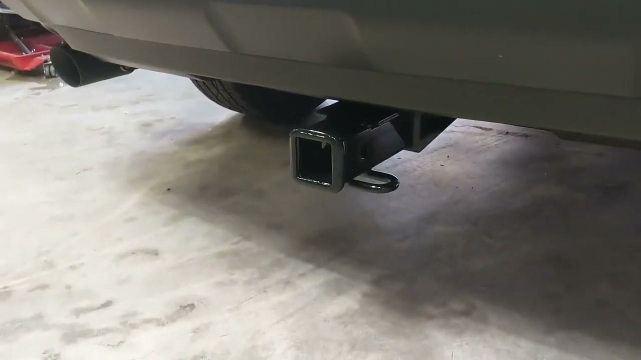 A Curt Class III 2-inch hitch receiver under the rear bumper of a 2021 RAV4