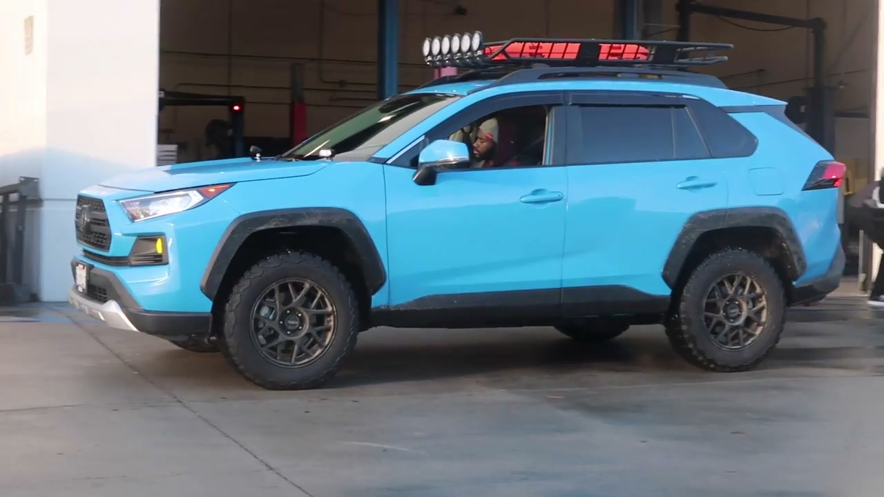 A blue 2019 RAV4 Adventure sitting higher after an Eibach Pro-Lift install