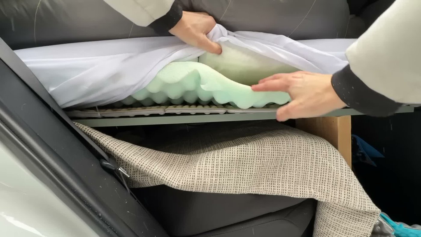 Layers on a RAV4 sleeping platform: a wooden platform, a reflective foam pad, egg-crate foam and a mattress