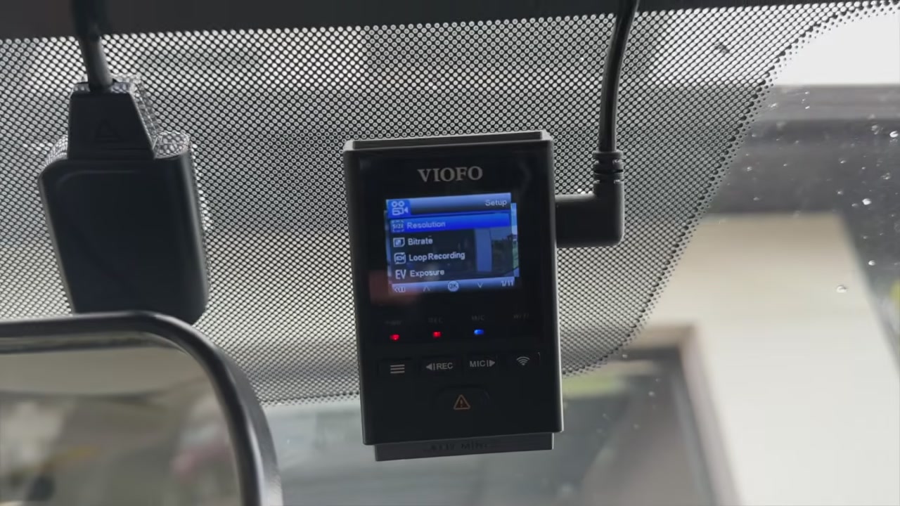 A VIOFO A119 Mini 2 with its menu on screen, mounted on the windshield of a Mazda 3
