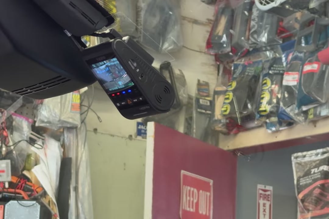 A VIOFO A229 Pro with its screen on, mounted behind the mirror of a 2022 to 2025 RAV4