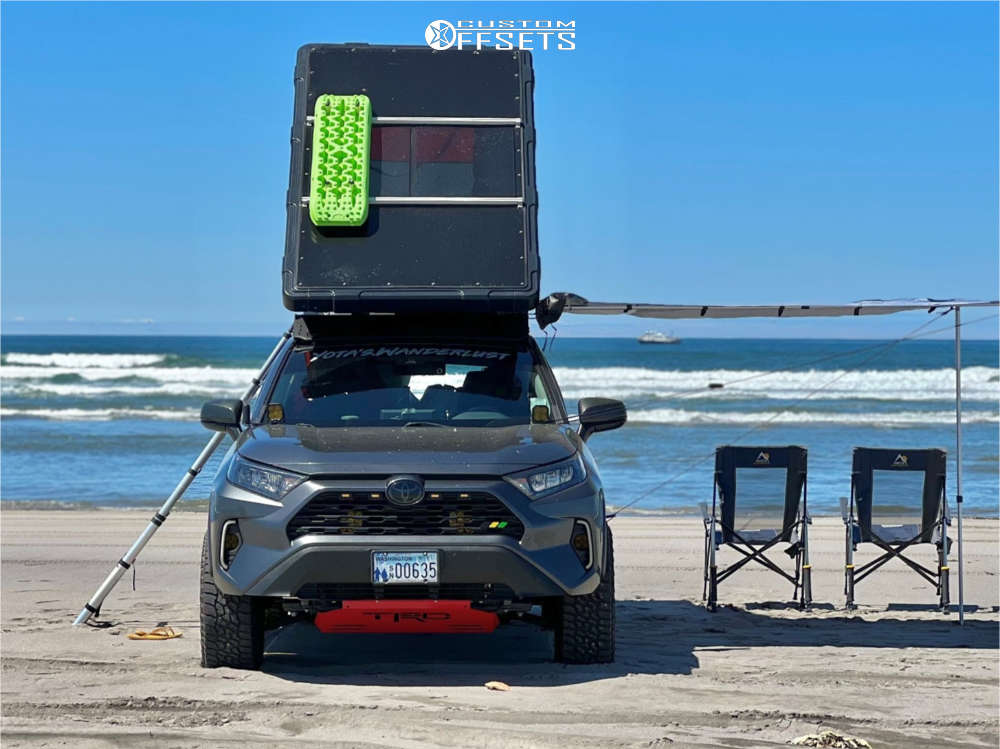 The same RAV4 camped on a beach with the rooftop tent open