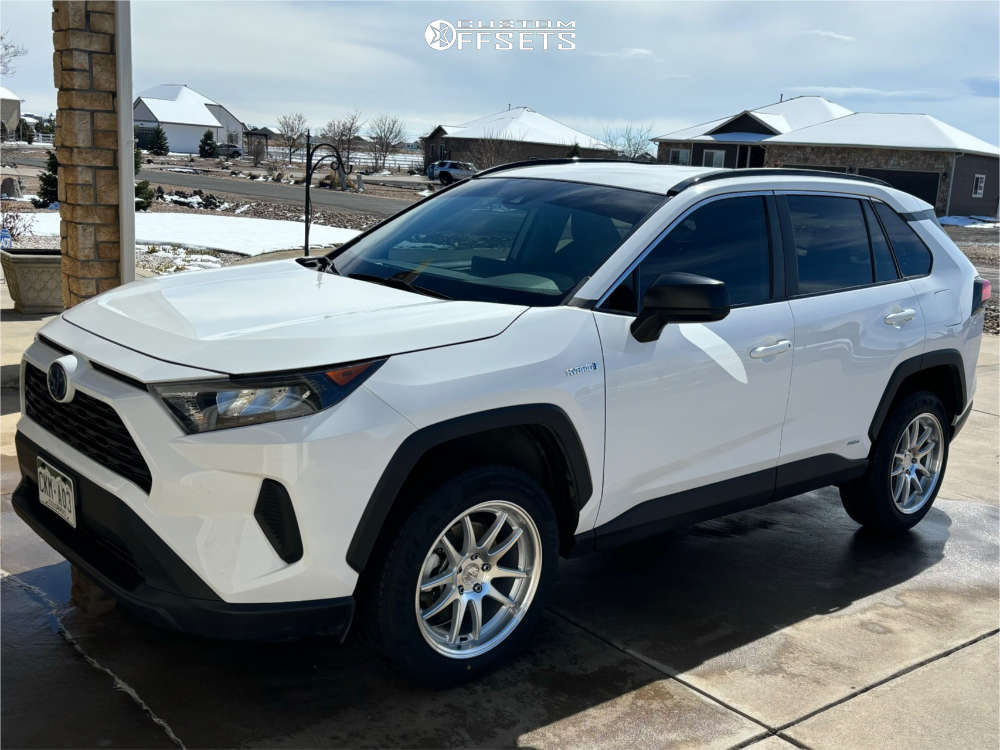 A white 2019 RAV4 Hybrid LE on silver Aodhan DS02 18-inch wheels with road tires