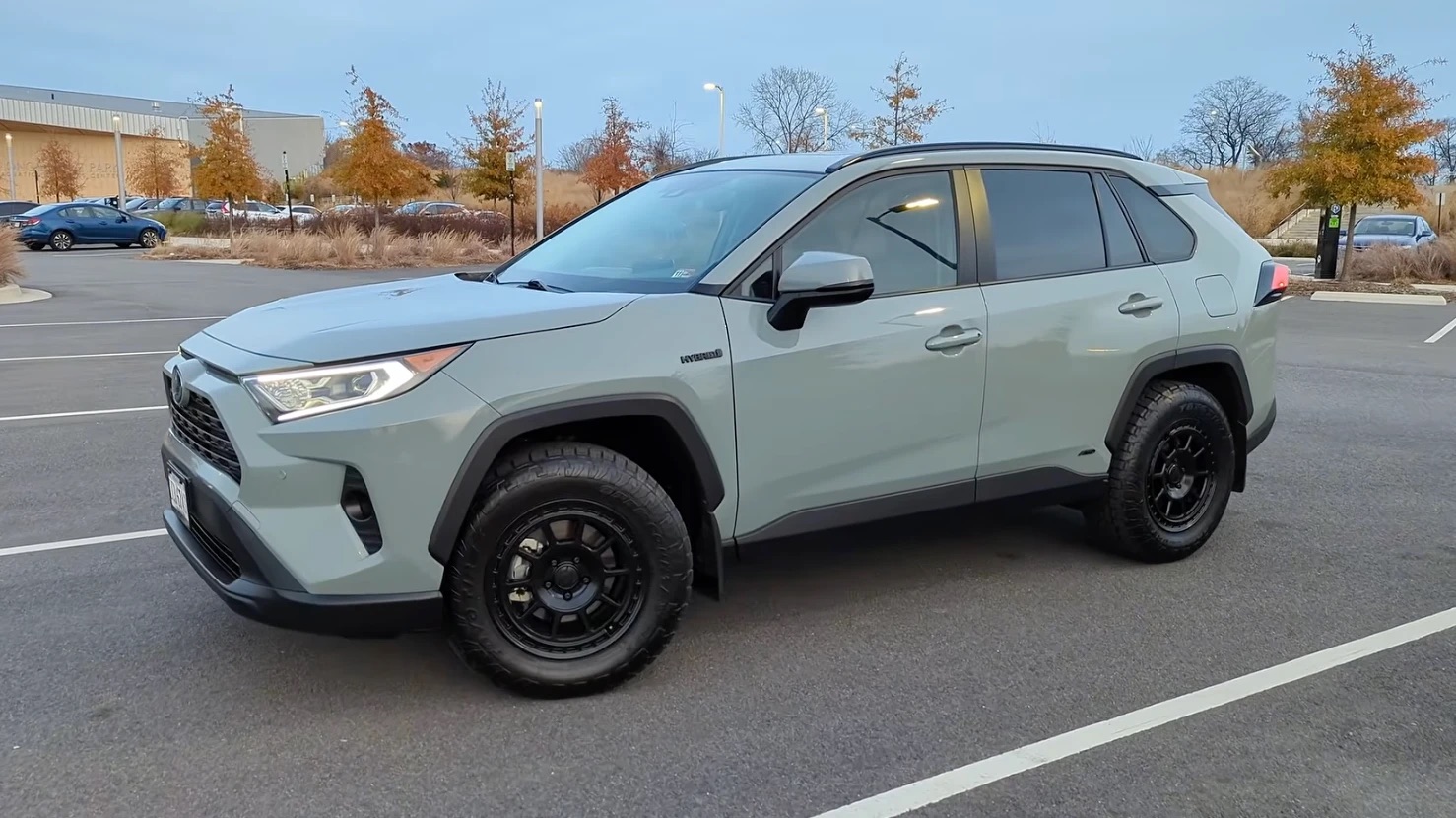 A Lunar Rock 2021 RAV4 Hybrid XLE Premium on Toyo Open Country A/T III tires in 245/65R17 and dark gray fifteen52 Traverse MX wheels, no lift