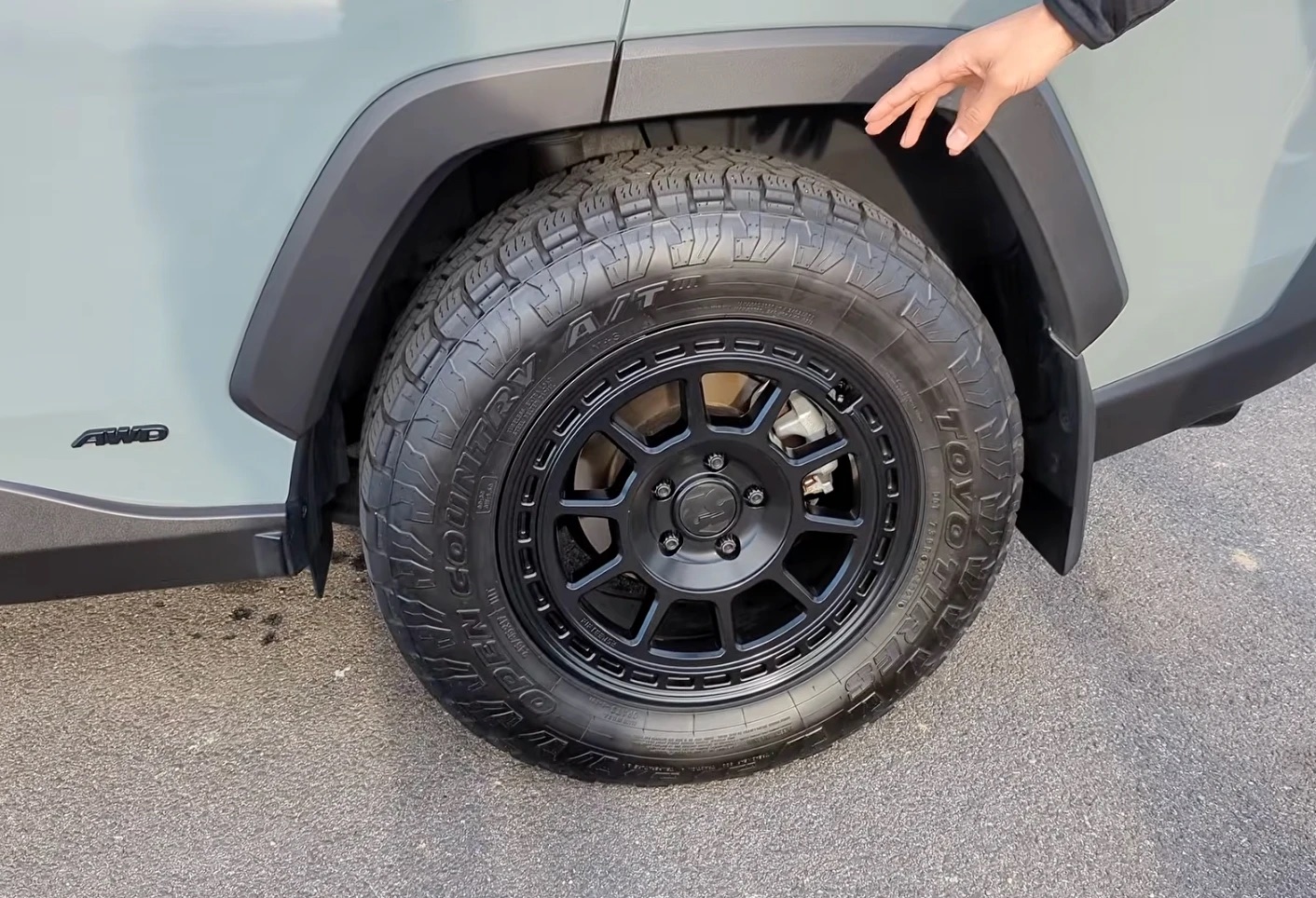 Close-up of the 245/65R17 Toyo A/T III on a 17x8 Fifteen52 Traverse MX wheel, showing the gap to the fender