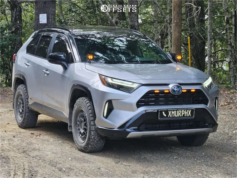 A silver 2023 RAV4 Hybrid XSE with a black roof on satin black KMC KM719 wheels and BFGoodrich KO2 tires in 235/65R17, stock height
