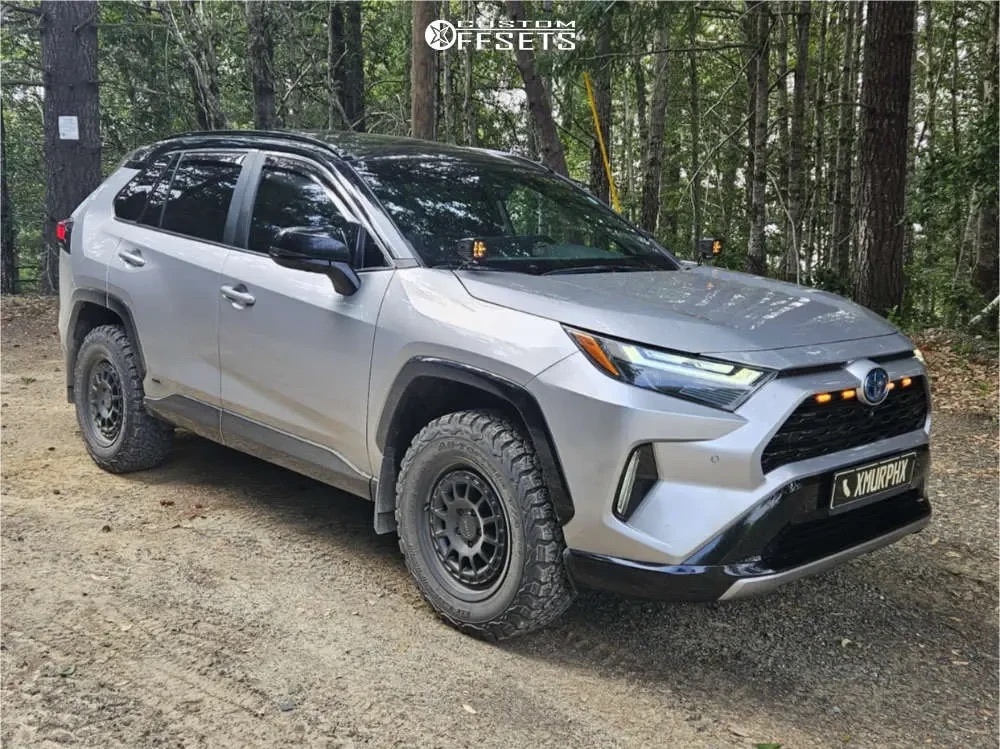 Side view of the same RAV4 Hybrid XSE on KO2 tires on a dirt road