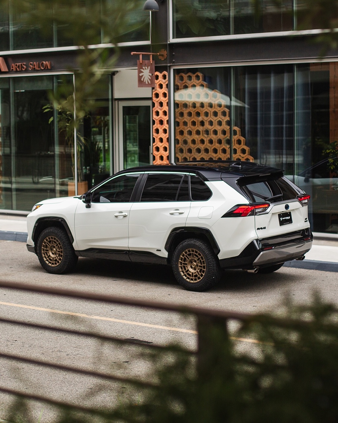 Rear three-quarter view of the white XSE on bronze FT109 wheels