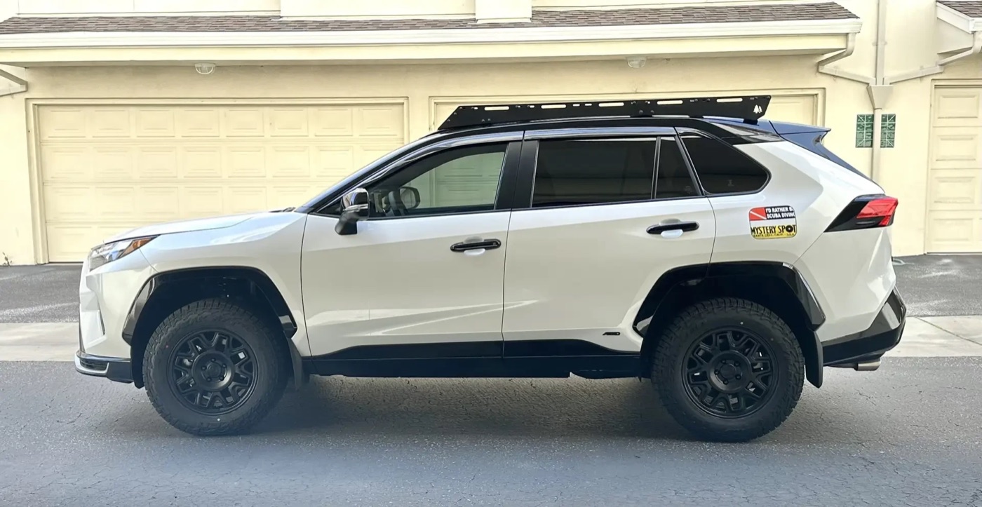 A white 2025 RAV4 Prime XSE with a black roof, a 2-inch lift, black fifteen52 Wander MX wheels and Falken Wildpeak A/T4W tires