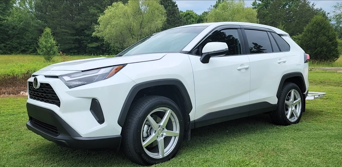 A white 2024 RAV4 on silver machined Voxx Modena wheels